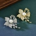 Shiny flower brooch with artificial pearls and silver Shiny flower brooch with artificial pearls and silver