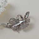 Shiny silver ribbon-shaped brooch Shiny silver ribbon-shaped brooch